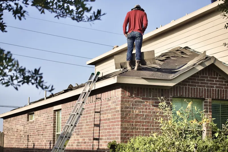 Professional roofer working on a residential roof in London Park Apartments